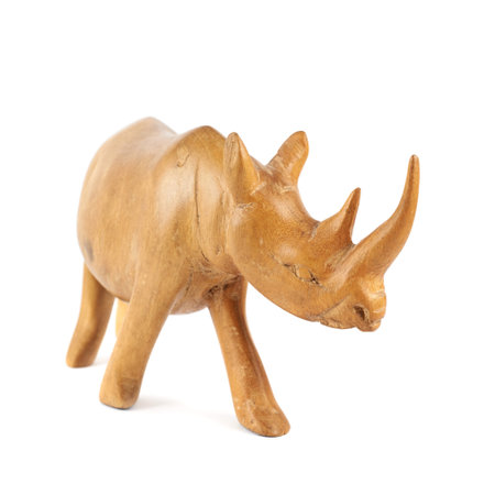 Rhinoceros rhino sculpture made of carved brown wood isolated over white backgroundの写真素材