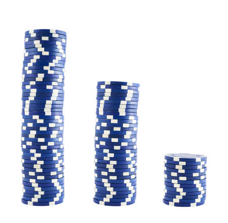 Three stacks of white and blue casino playing chips isolated over white backgroundの写真素材