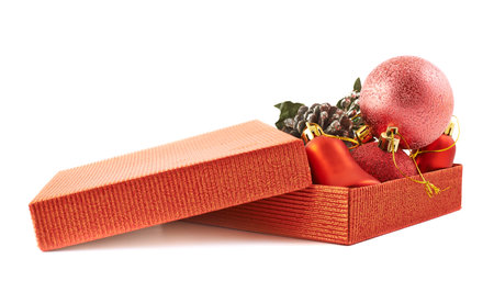 Red gift box full of christmas decorations isolated over white background