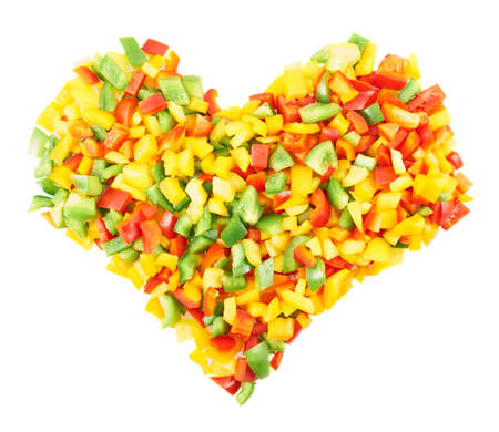 Heart shaped composition of sliced colorful sweet bell peppers isolated over a white backgroundの写真素材