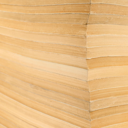 Fragment of old books stack as a background texture, shallow depth of field focused to the corner