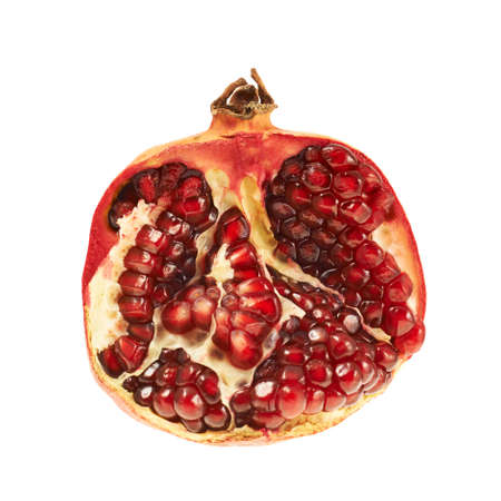 Sliced half of a pomegranate fruit isolated over white backgroundの写真素材