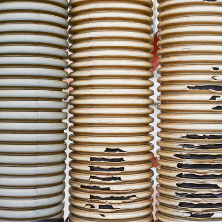 Three old and threadbare plastic tubes compositionの写真素材