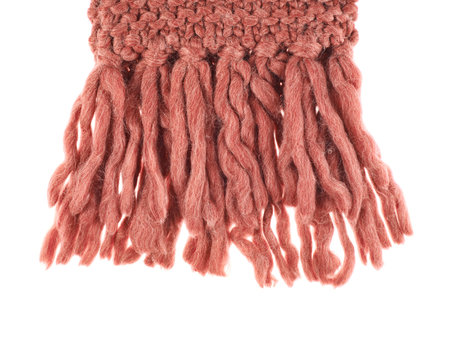 Tip of the knitted red scarf isolated over the white background