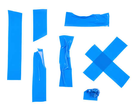 Multiple pieces of blue insulating tape of different shapes, isolated over the white backgroundの写真素材