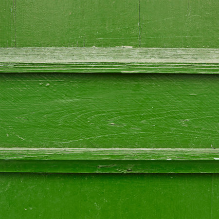 Painted green wooden fence fragment as a background textureの写真素材