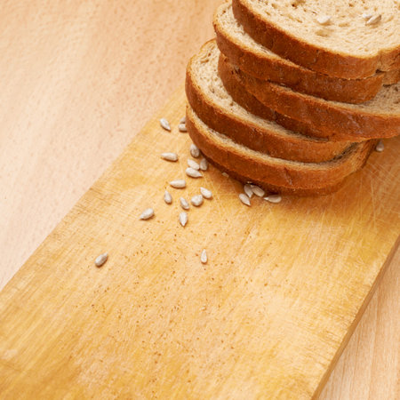 Bread and sunflower seeds over the cutting board composition