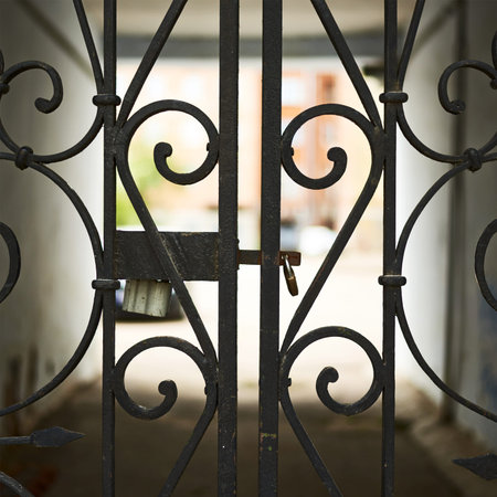 Gateway behind the wrought-iron gates fragment, shallow depth of field