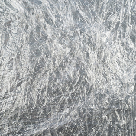 Fragment of a surface covered with multiple layers of a cling polyethylene film as a background...