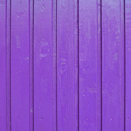 Painted violet wooden fence fragment as a background textureの写真素材