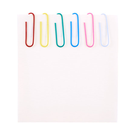 Six colorful office paper clips clipped to a square sheet of paper, isolated over the white...