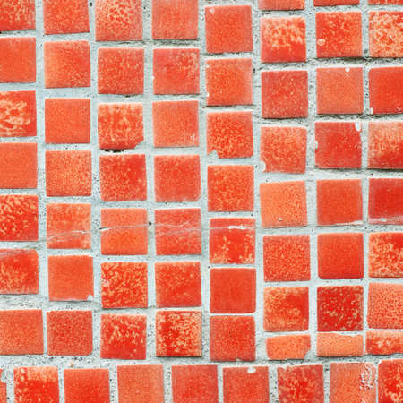 Floor ceramic squared red old dirty tiles fragment as an abstract background textureの写真素材