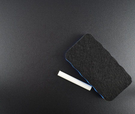 Black board with a special rug and piece of chalk over it