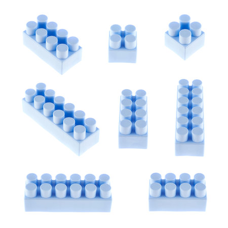 Set of plastic blue toy construction block bricks in multiple foreshortenings, isolated over the white backgroundの写真素材