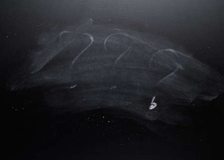 Three question marks erased from the blackboardの写真素材