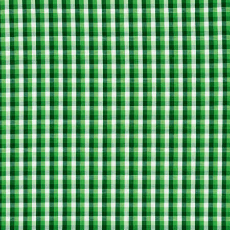 Squared green cloth fabric fragment as a background texture compositionの写真素材