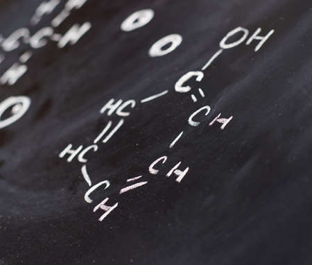 Blackboard with some chemistry structures drawn with chalk as a background composition with a shallow depth of fieldの写真素材
