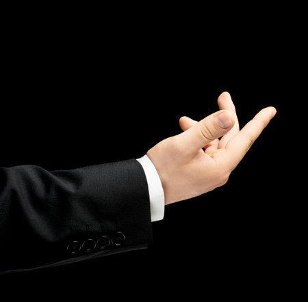 Caucasian male hand in a business suit, showing the asking for help gesture sign, low-key lighting...