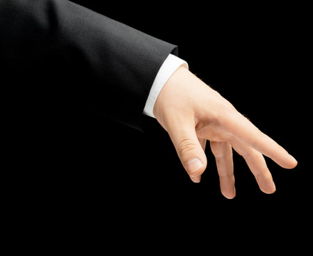 Caucasian male hand in a business suit, low-key lighting composition, isolated over the black backgroundの写真素材