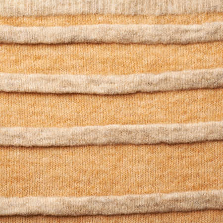Knitted beige cloth material fragment as a background texture compositionの写真素材
