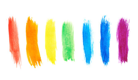 Seven rainbow colored watercolor paint strokes over the white backgroundの写真素材