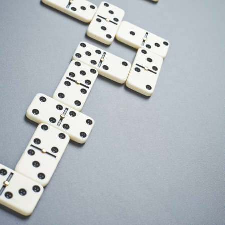 White domino bones composition over the gray background surfaceの写真素材