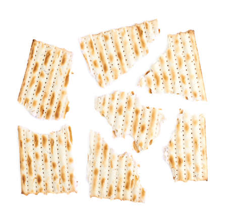 Cracked in multiple pieces machine made matza flatbread, composition isolated over the white backgroundの写真素材