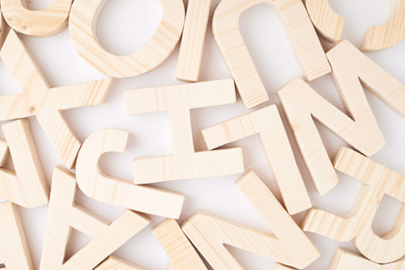 Surface covered with multiple wooden letters as a background compositionの写真素材