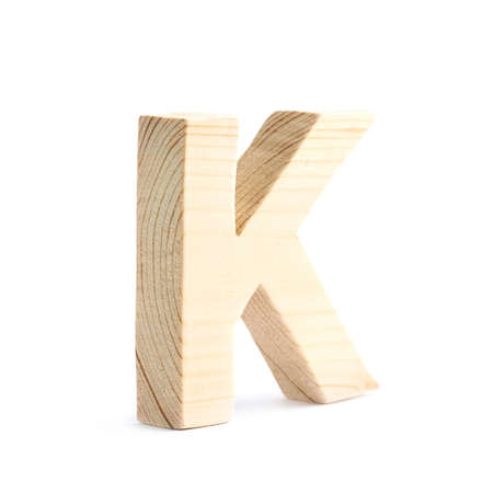 Wooden block K letter isolated over the white backgroundの写真素材