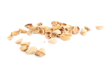 Pile of multiple pistachio shells isolated over the white background