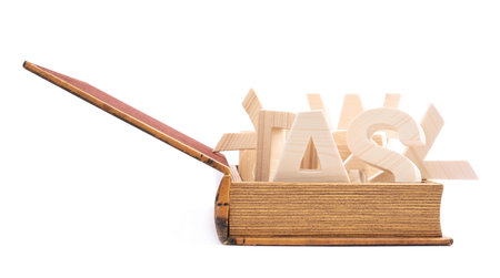 Multiple wooden letters in a book shaped casket, composition isolated over the white backgroundの写真素材