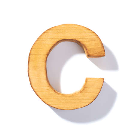 Single brown wooden C letter with 45 degree long shadow as a real life flat design font, isolated over the white backgroundの写真素材