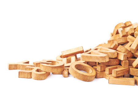Pile of wooden block letters isolated over the white background as a typography background...