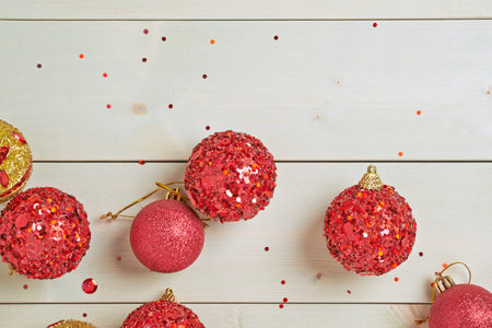 Festive Christmas and New Year background composition of multiple decoration balls over the wooden...