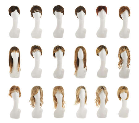 Hair wig over the white plastic mannequin head isolated over the white background, set of multiple different wigs in the front foreshorteningの写真素材