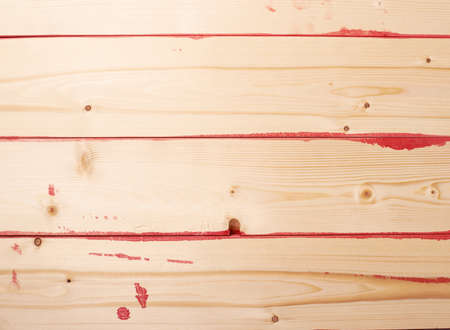 Surface covered with multiple pine wood boards with the paint stains and leaks in the gaps, as an abstract background compositionの写真素材