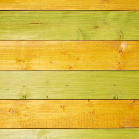 Colorful paint coated pine wood boards fragment as a background compositionの写真素材