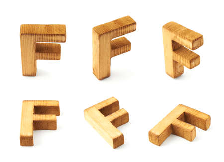 Set of six block wooden capital F letters in different foreshortenings isolated over the white backgroundの写真素材