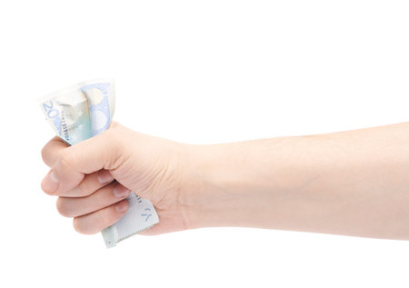Hand squeezing twenty euro note, composition isolated over the white background