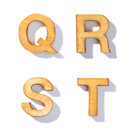 Set of brown wooden symbols Q, R, S, T with 45 degree long shadow as a real life flat design font elements, isolated over the white backgroundの写真素材