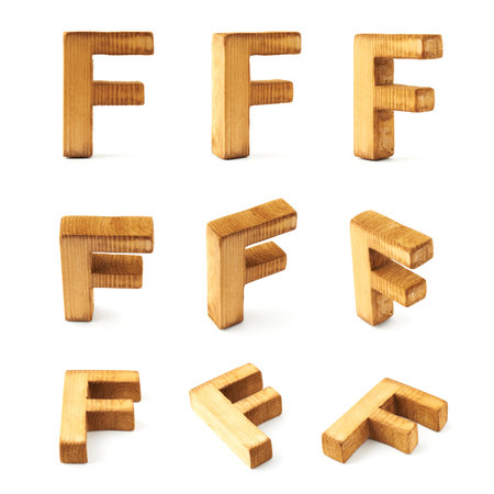 Set of nine block wooden capital F letters in different foreshortenings isolated over the white backgroundの写真素材