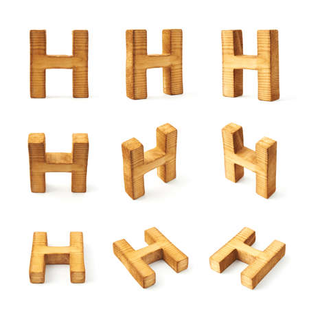 Set of nine block wooden capital H letters in different foreshortenings isolated over the white backgroundの写真素材