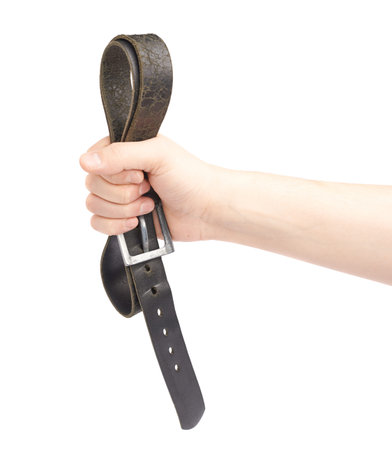 Male hand holding a black leather belt, composition isolated over the white backgroundの写真素材