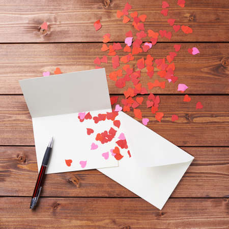 Empty copyspace valentine card or love letter composition over the wooden boards covered surfaceの写真素材