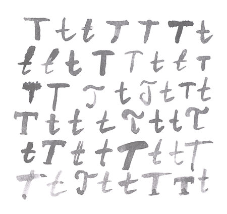 Set of multiple hand drawn with black watercolor ink T letters isolated over the white backgroundの写真素材