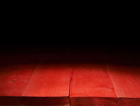 Red paint coated wooden boards copyspace background composition with the low key lightingの写真素材
