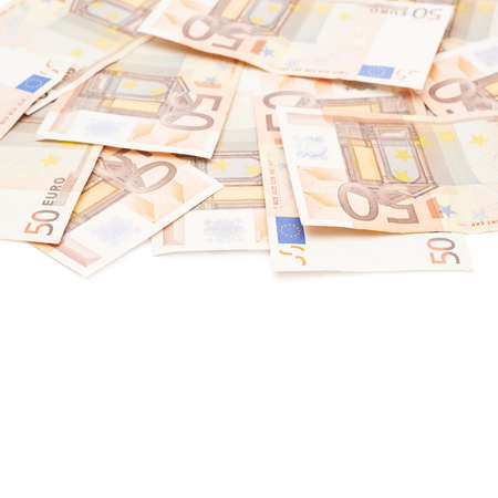 Surface covered with multiple fifty euro bank notes isolated over the white backgroundの写真素材