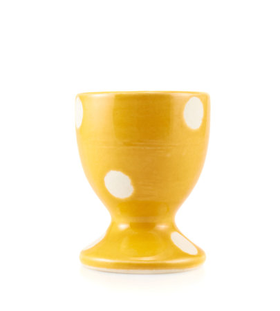 Colorful empty yellow egg holder isolated over the white background