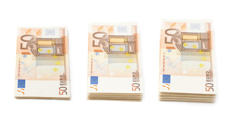 Growing stack pile of fifty euro bank notes isolated over the white background