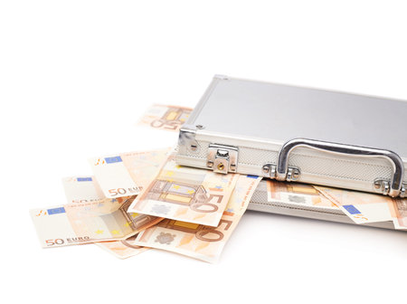 Suitcase full of fifty euro bank note bills isolated over the white background